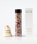 white box, shemana logo, tall plastic bottle filled with pink bath salts and wildflowers, black  lid, shemana cotton small bag